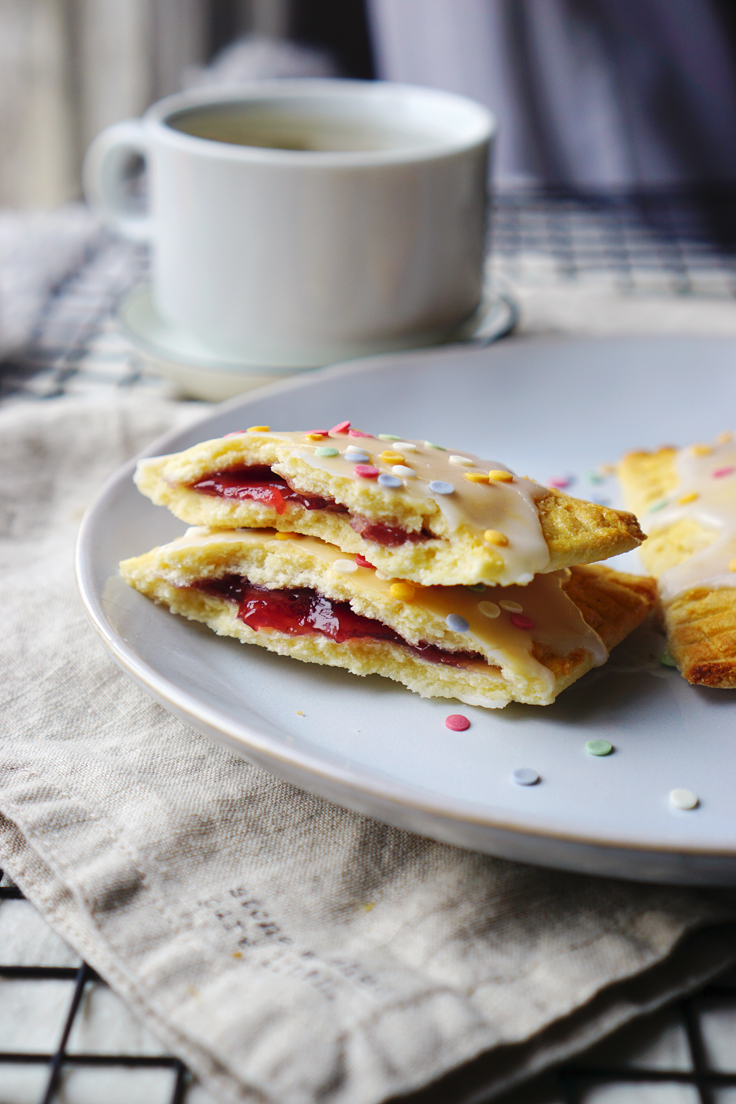 Homemade gluten free pop tarts made with a low carb coconut shortcrust pastry and decorated with icing and Waitrose fruity confetti.