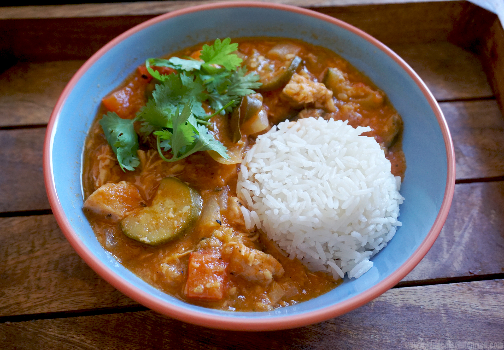 Healthy low carb coconut chicken stew served with rice and fresh coriander