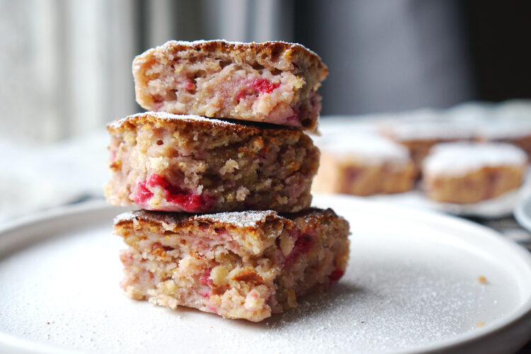 Gluten free oat and raspberry muffin traybake with a sprinkle of icing sugar on top