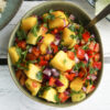 Delicious, healthy colourful mango salad with bell peppers, red onion, parsley, chilli and lime