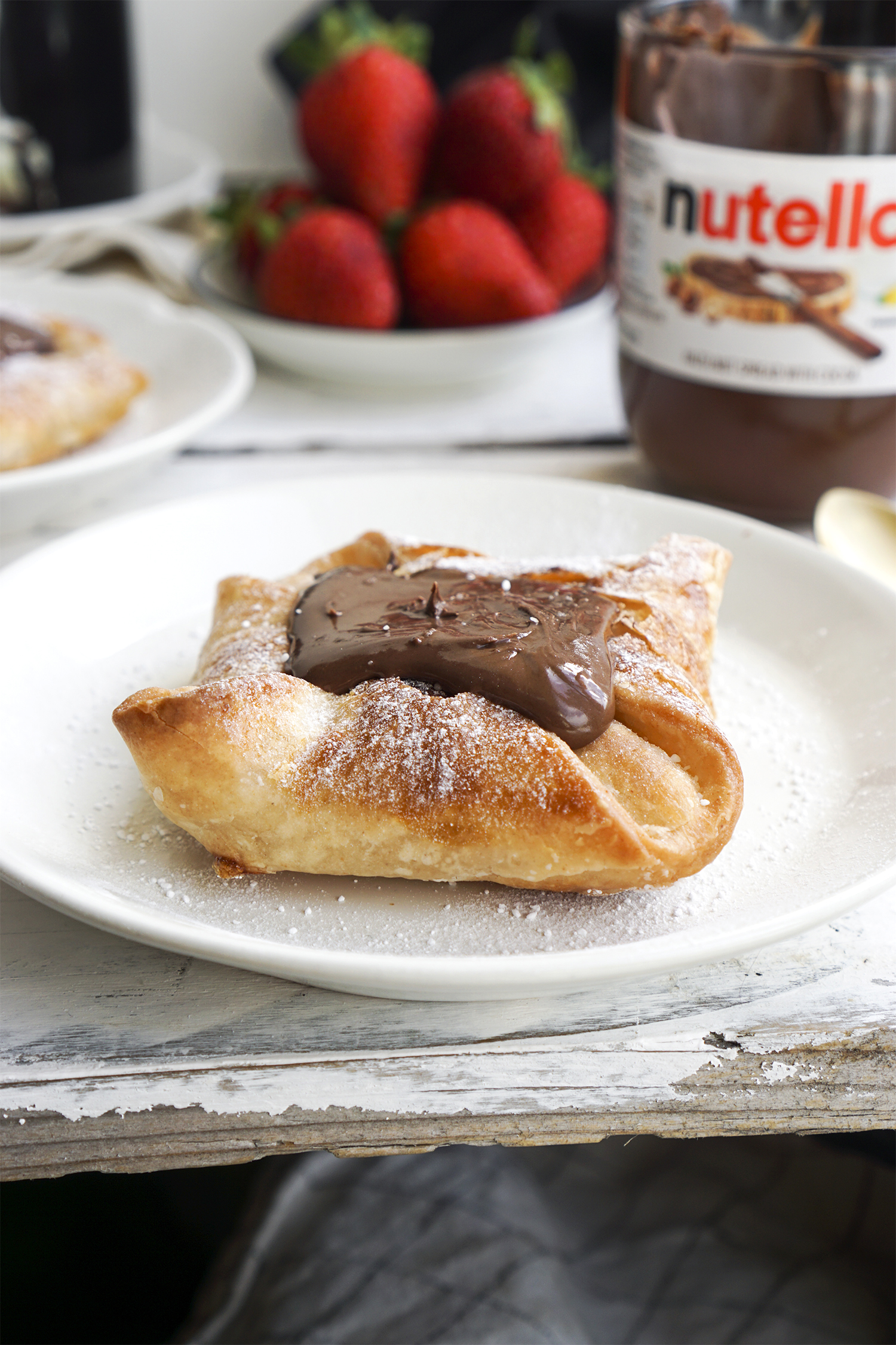 Quick and easy chocolate Danish pastries made using Jus Rol gluten free puff pastry and a big dollop of Nutella - served for breakfast with tea and fresh strawberries